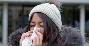 woman blowing nose